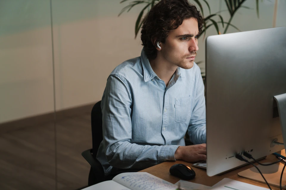 Homme en costume sombre manipulant une interface de sécurité digitale avec cadenas bleu lumineux au centre d'anneaux circulaires